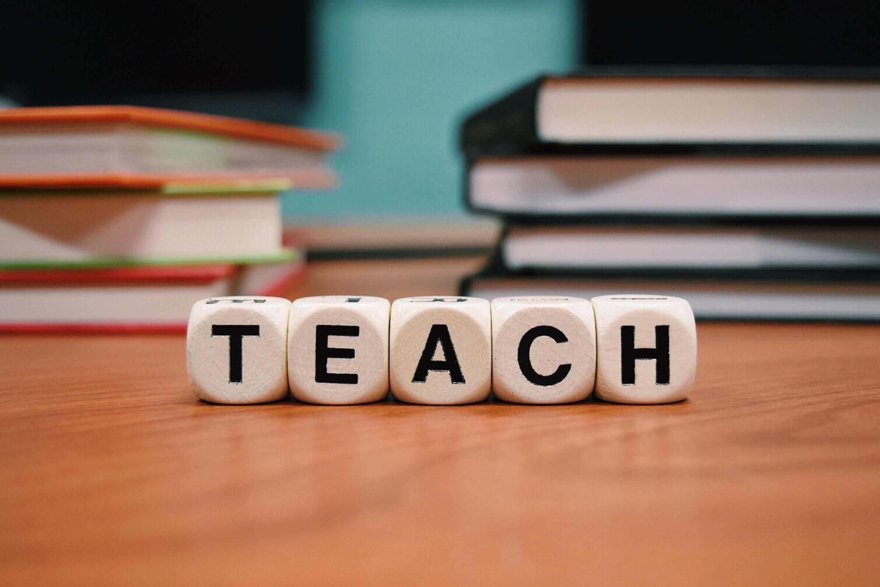 Letter blocks that spell teach.